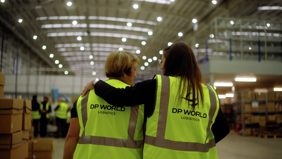 Two DP World female employees are talking to each other in a Bicester warehouse.