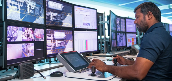 DP World technician monitoring logistics operations from a high-tech control center