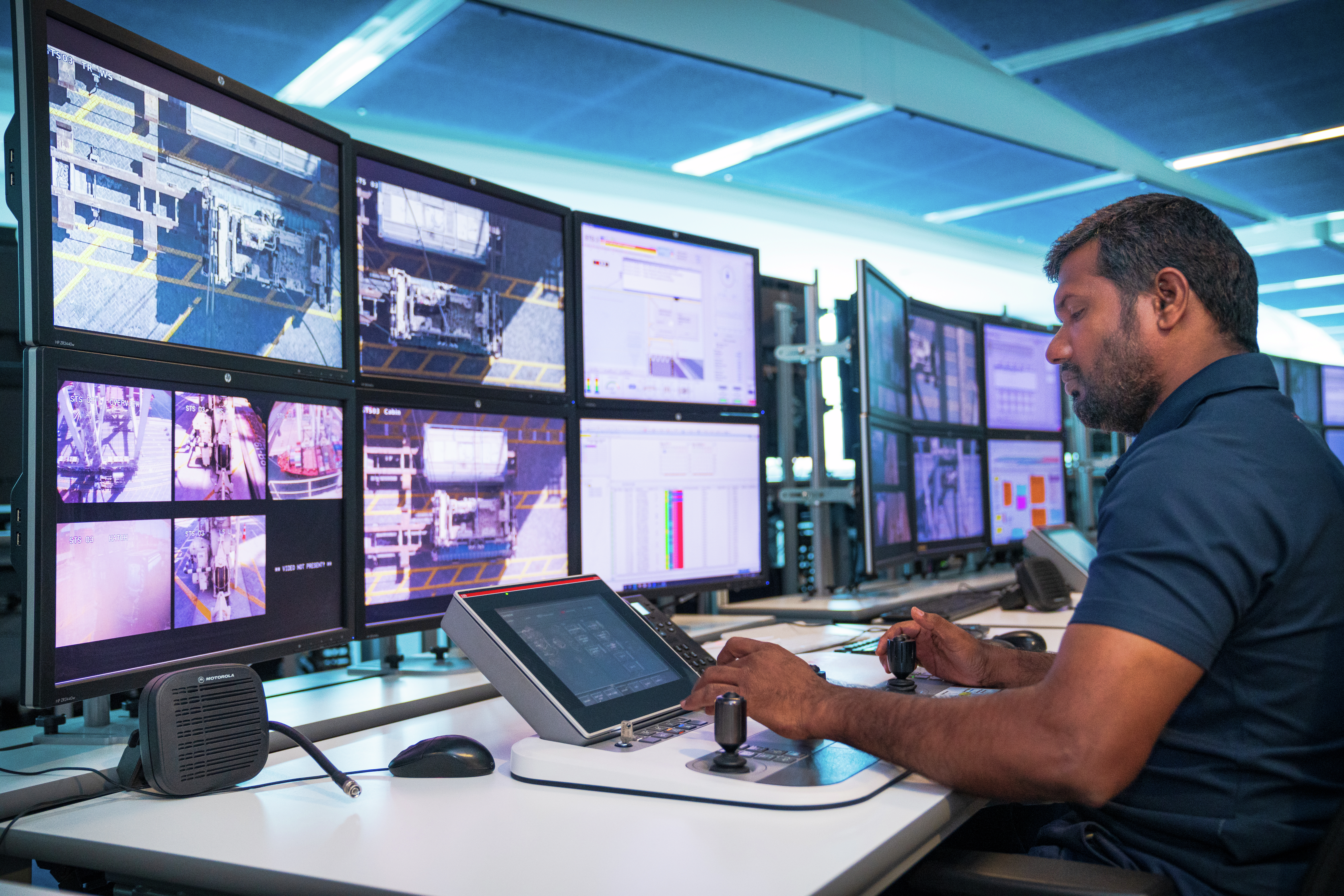 DP World technician monitoring logistics operations from a high-tech control center