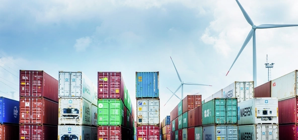 Wind turbines near port container to show greener ports 