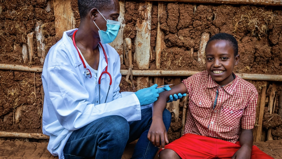 Medical Professional Assisting Child With Healthcare Checkup