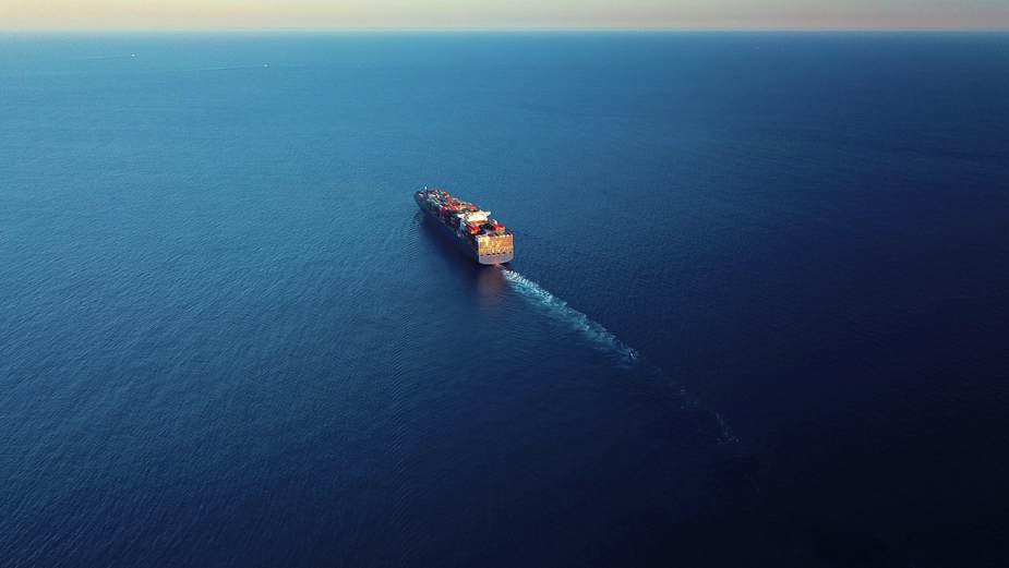 Aerial view of a cargo ship sailing under clear skies as part of DP World’s global fleet