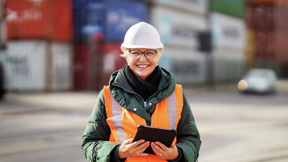 DP World female employee using a tablet at the terminal