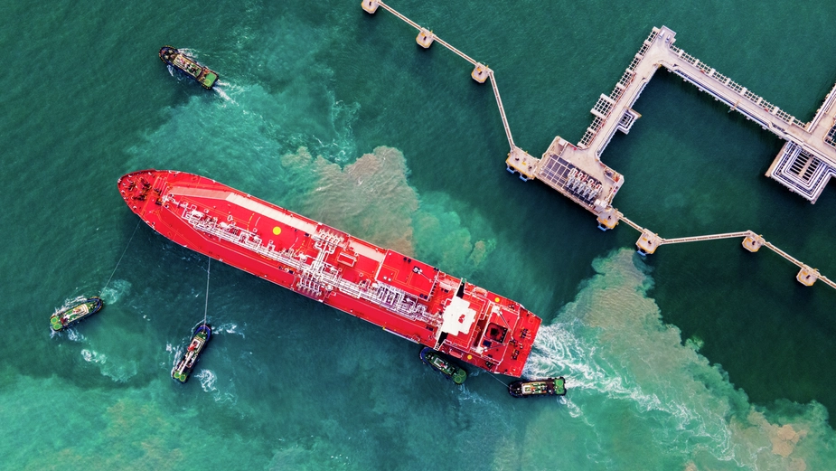 Oil tanker docked at port with marine infrastructure